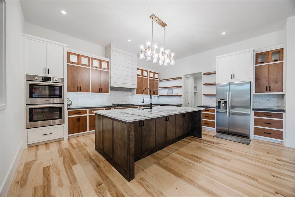 2081 Holt Way Grapevine, TX 76051 - Photo 7 of 40 a kitchen with stainless steel appliances granite countertop a refrigerator a stove and a sink