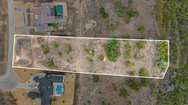an aerial view of a house with a yard basket ball court and outdoor seating