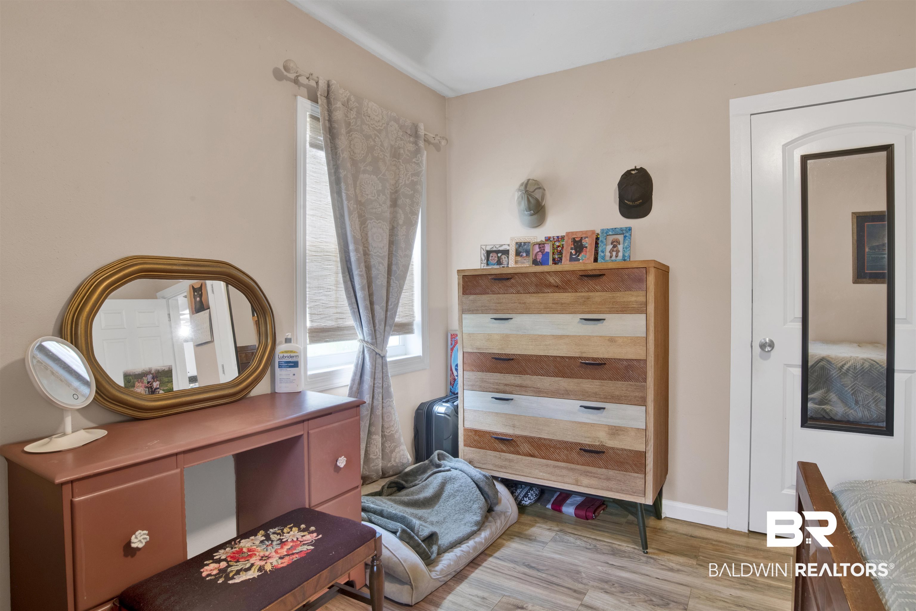 1100 North Pine Street Foley, AL 36535 - Photo 13 of 30 Interior space featuring light-toned walls, wood-finish flooring, and a white window frame with blinds