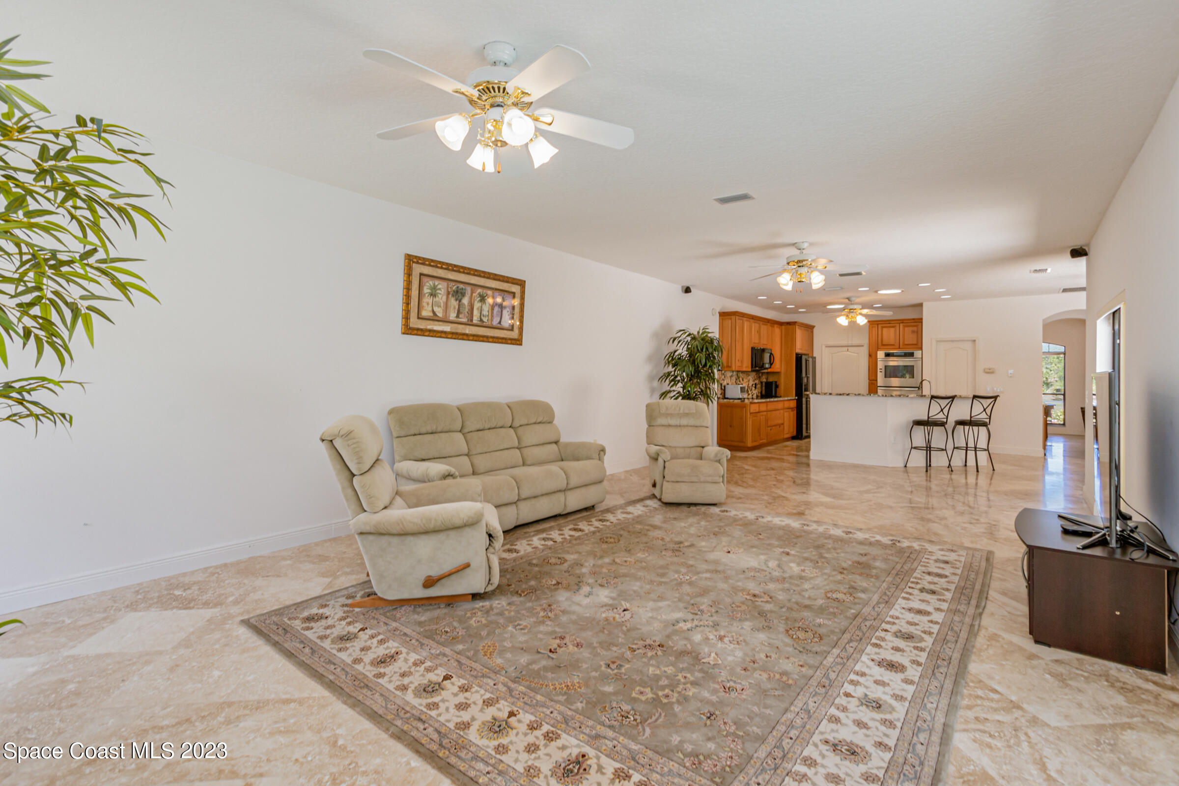 271 Deer Run Road Palm Bay, FL 32909 - Photo 28 of 61 a living room with furniture and a chandelier