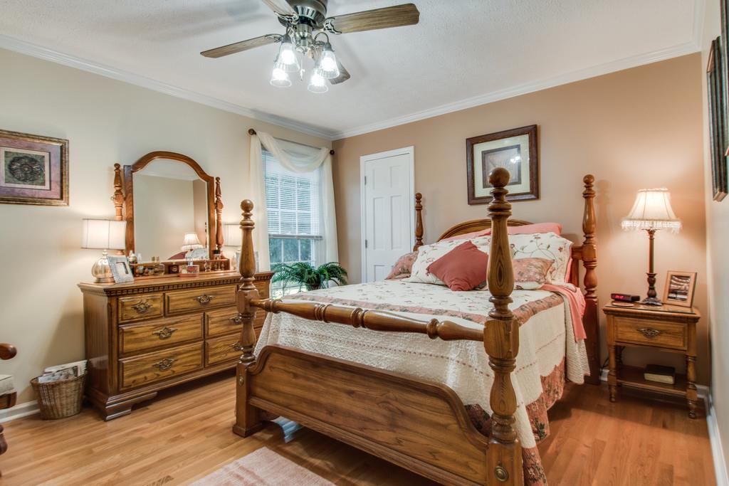 4850 Mt Zion Road Springfield, TN 37172 - Photo 14 of 28 a bedroom with a bed and a chandelier