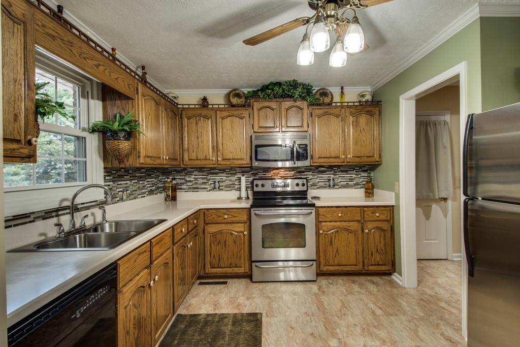 4850 Mt Zion Road Springfield, TN 37172 - Photo 8 of 28 a kitchen with stainless steel appliances granite countertop a sink cabinets a refrigerator and a stove