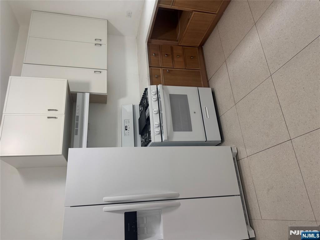 32 Jacoby Street, Unit 1 Maplewood, NJ 07040 - Photo 12 of 14 a kitchen with cabinets and white stainless steel appliances