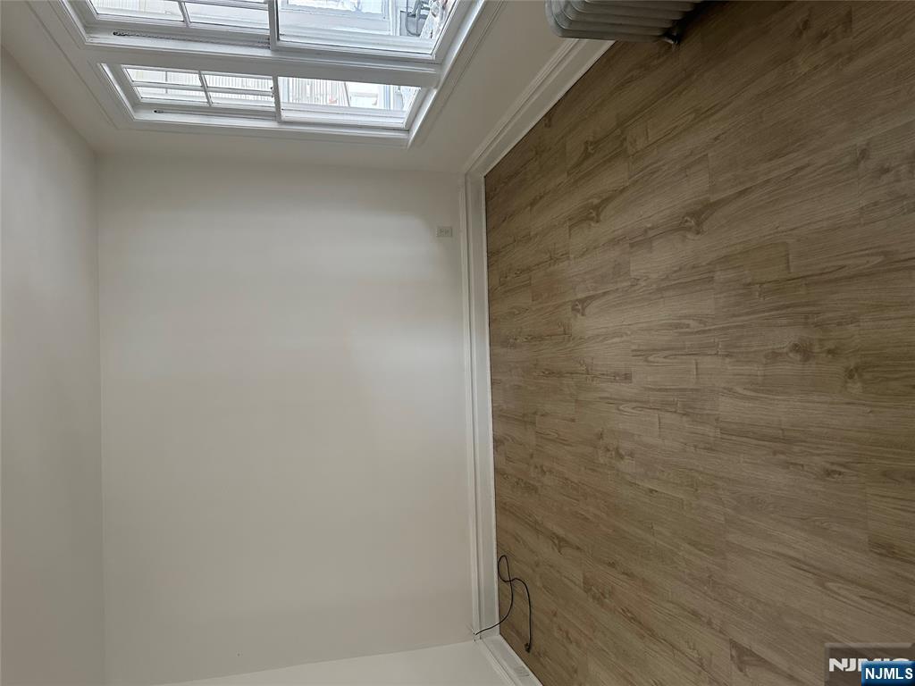 32 Jacoby Street, Unit 1 Maplewood, NJ 07040 - Photo 3 of 14 an empty room with wooden floor and windows