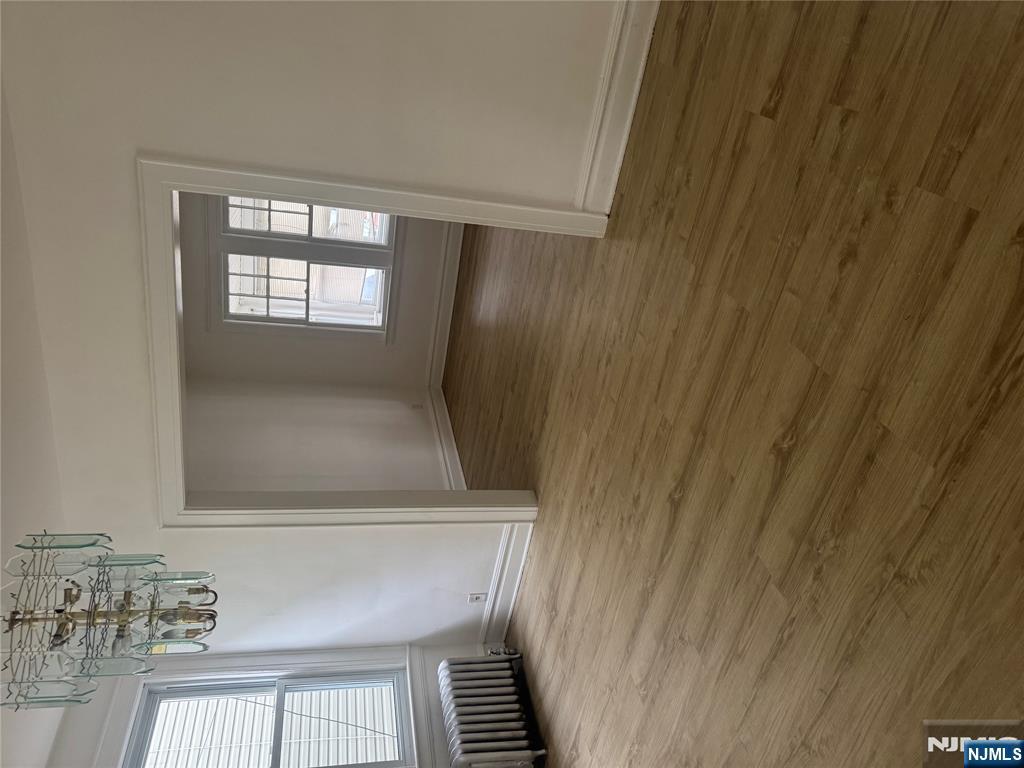 32 Jacoby Street, Unit 1 Maplewood, NJ 07040 - Photo 4 of 14 an empty room with wooden floor and windows