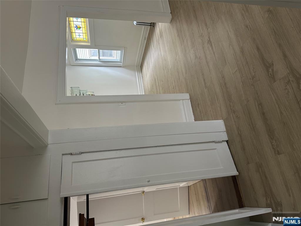 32 Jacoby Street, Unit 1 Maplewood, NJ 07040 - Photo 5 of 14 a view of an empty room with wooden floor and a window