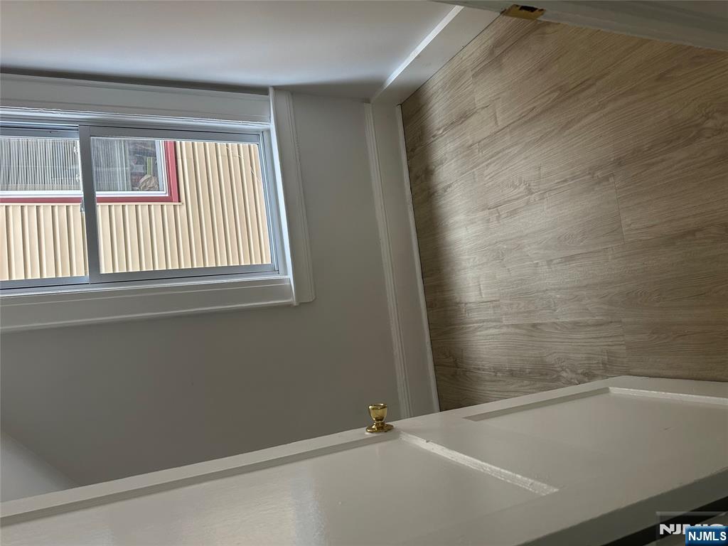 32 Jacoby Street, Unit 1 Maplewood, NJ 07040 - Photo 6 of 14 an empty room with wooden floor and windows