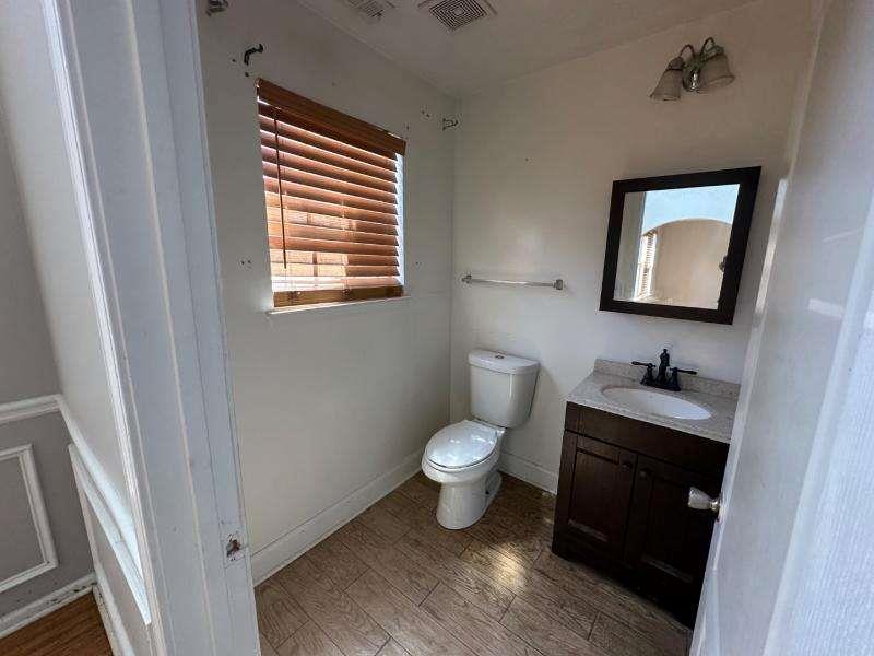 485 Brunswick Circle Stockbridge, GA 30281 - Photo 11 of 31 a bathroom with a toilet a sink and mirror