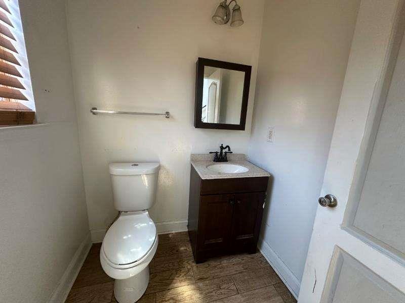 485 Brunswick Circle Stockbridge, GA 30281 - Photo 12 of 31 a bathroom with a toilet sink and mirror