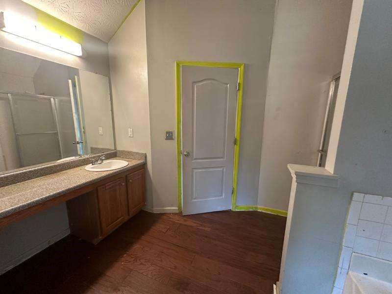485 Brunswick Circle Stockbridge, GA 30281 - Photo 17 of 31 a spacious bathroom with a granite countertop sink and a mirror