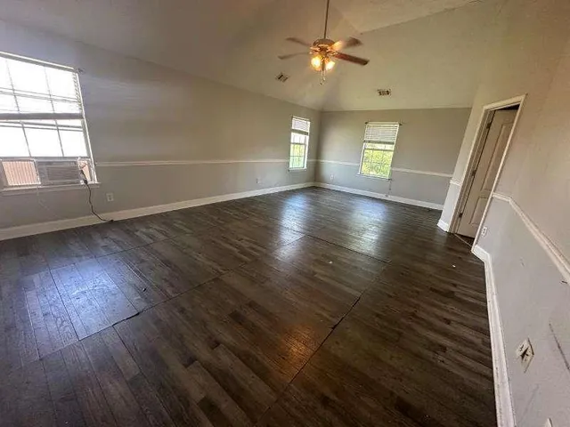 wooden floor in an empty room with a window