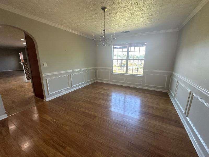 485 Brunswick Circle Stockbridge, GA 30281 - Photo 5 of 31 a view of empty room with wooden floor and fan