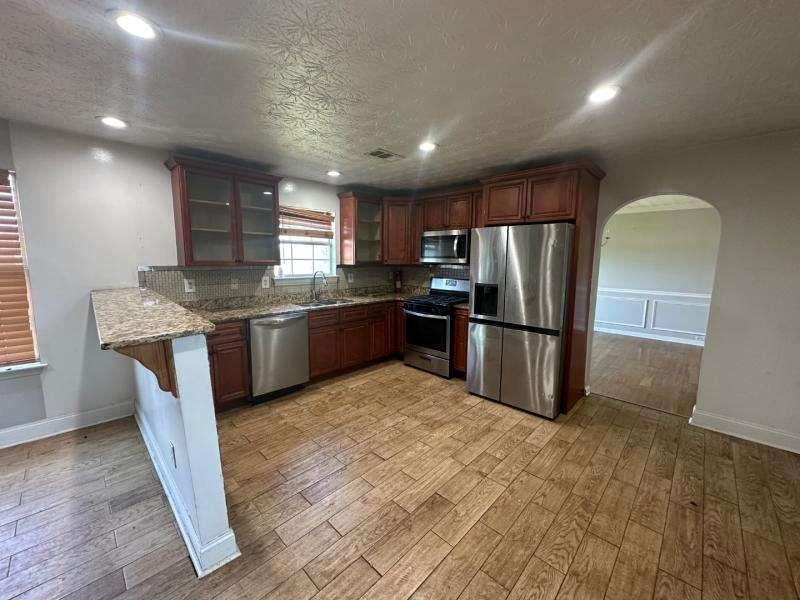 485 Brunswick Circle Stockbridge, GA 30281 - Photo 9 of 31 a kitchen with stainless steel appliances granite countertop a sink a stove a refrigerator and island