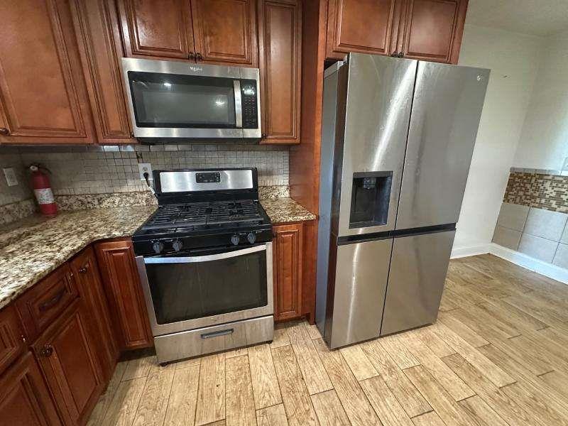 485 Brunswick Circle Stockbridge, GA 30281 - Photo 10 of 31 a kitchen with granite countertop a refrigerator and a stove top oven