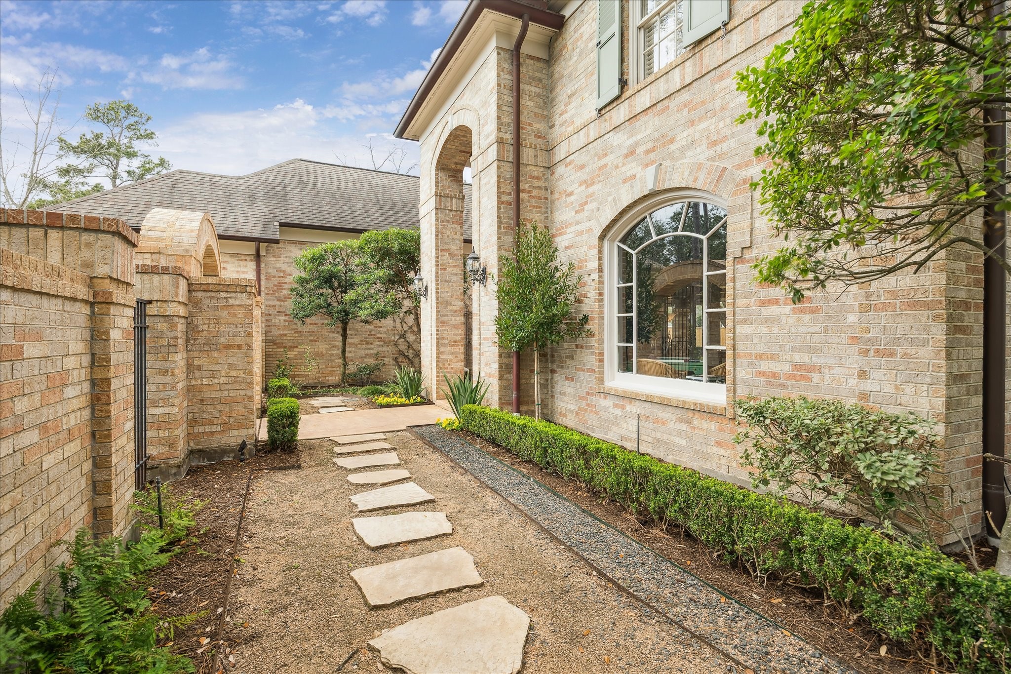 11524 Taylorcrest Road Houston, TX 77024 - Photo 8 of 47 Another view of the courtyard beyond the front brick wall.