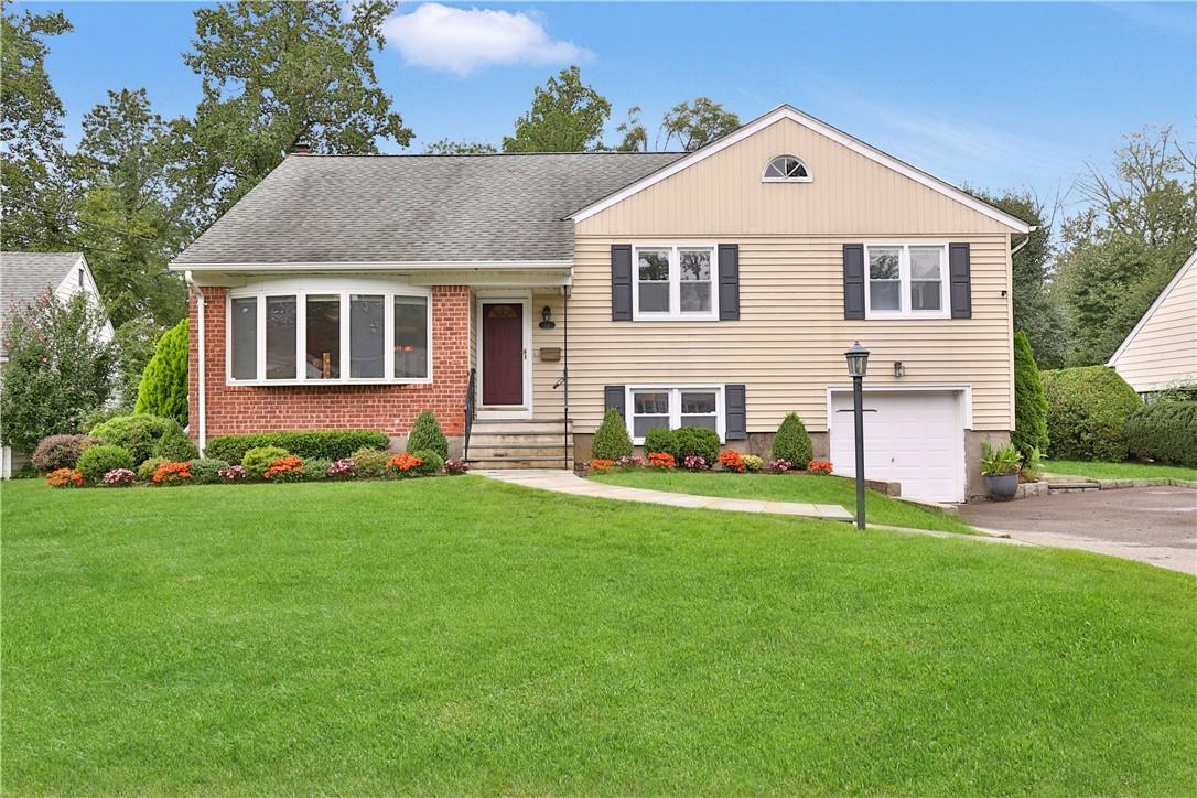 26 Primrose Road Scarsdale, NY 10583 - Photo 1 of 1 a front view of a house with a yard and garage