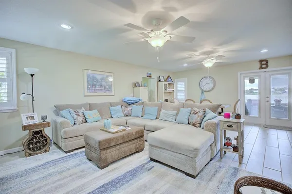 a living room with furniture and a chandelier