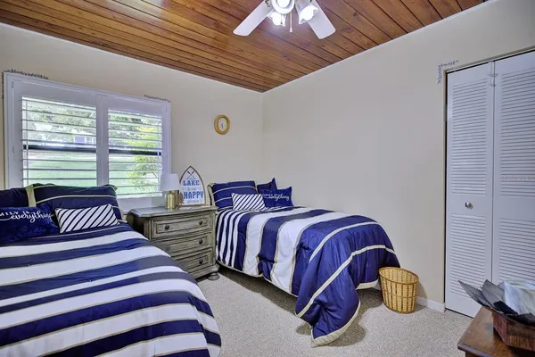 a bedroom with two beds and a chandelier