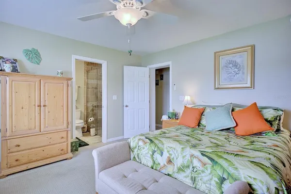 a bedroom with a large bed and a chandelier