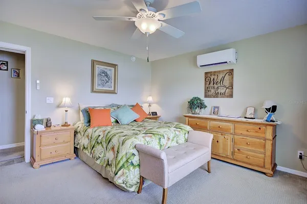 a bedroom with a bed and a dresser in it