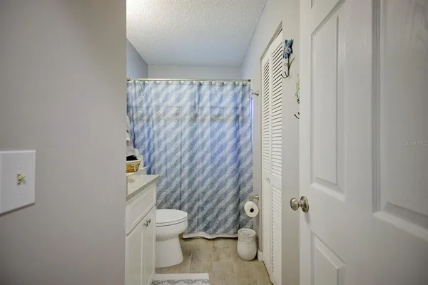 a bathroom with a toilet and a shower curtain
