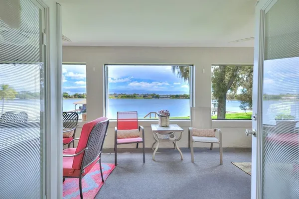 a view of a workspace with furniture and a window