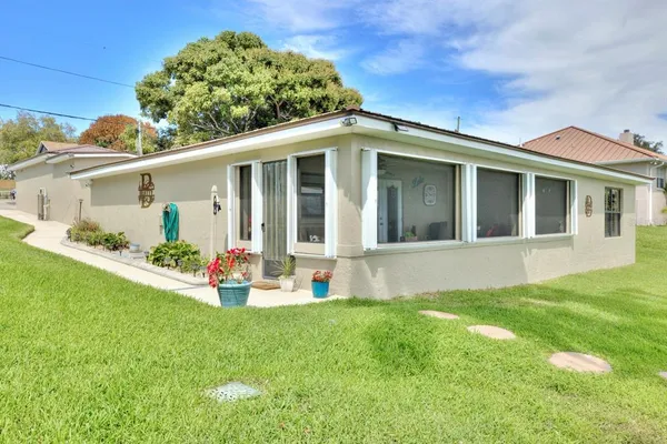 a view of an house with backyard space and garden