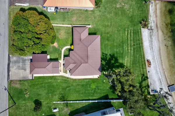 an aerial view of a house with a garden and plants