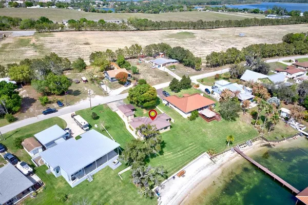 an aerial view of residential houses with outdoor space and river