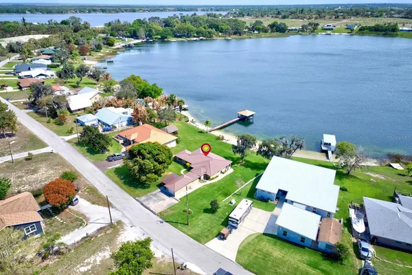 an aerial view of a house with a lake view