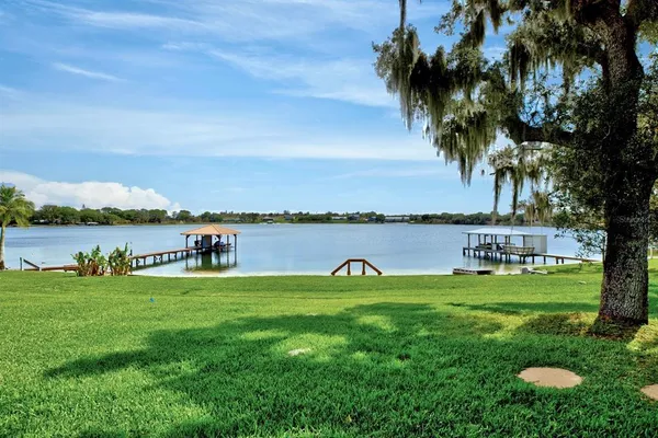 a backyard of a house with table and chairs