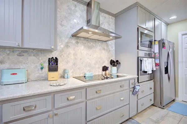 a kitchen with cabinets appliances and a counter top space