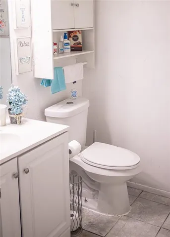 a bathroom with a sink toilet and a mirror