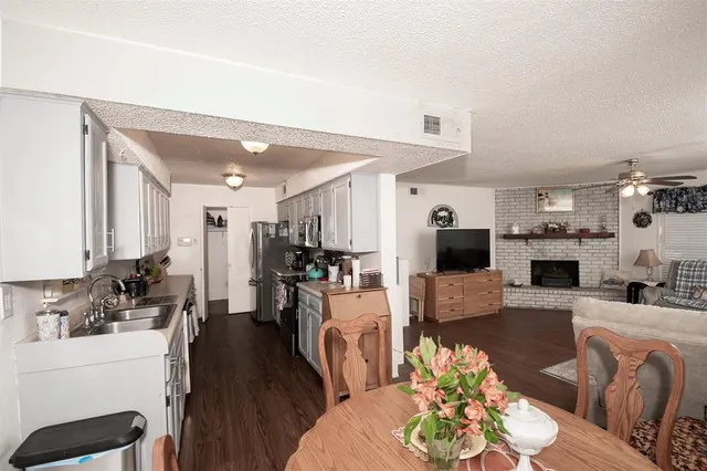 a living room with furniture a wooden floor and a fireplace