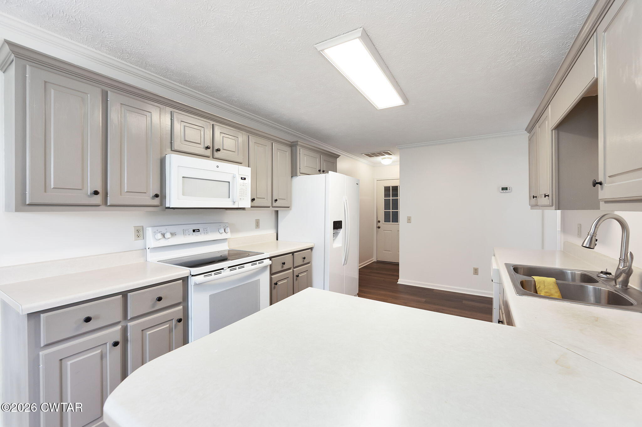 96 Sundown Drive Jackson, TN 38305 - Photo 10 of 28 a kitchen with white cabinets and stainless steel appliances