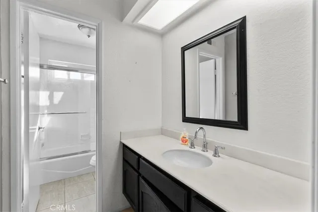 a bathroom with a sink vanity and a mirror