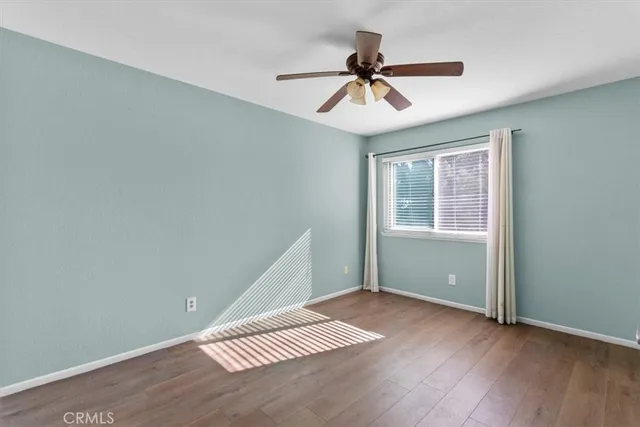 a view of room with hardwood floor and ceiling fan