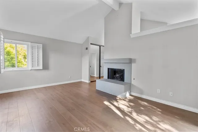 wooden floor fireplace and natural light in room