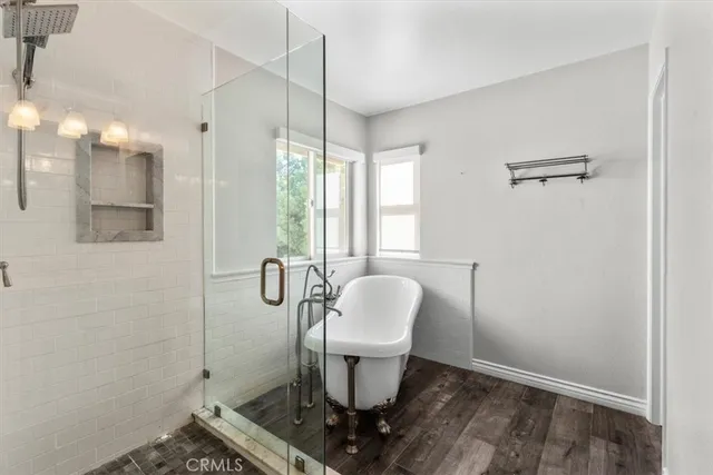 a bathroom with a granite countertop sink a toilet and shower