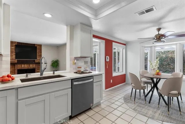 a kitchen with a sink and chairs