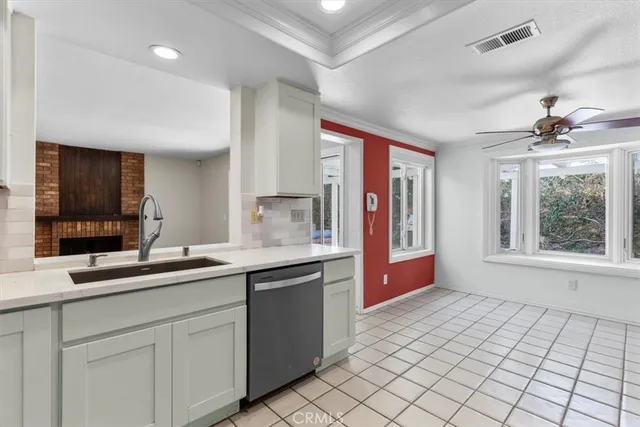 a kitchen with a sink and a stove top oven
