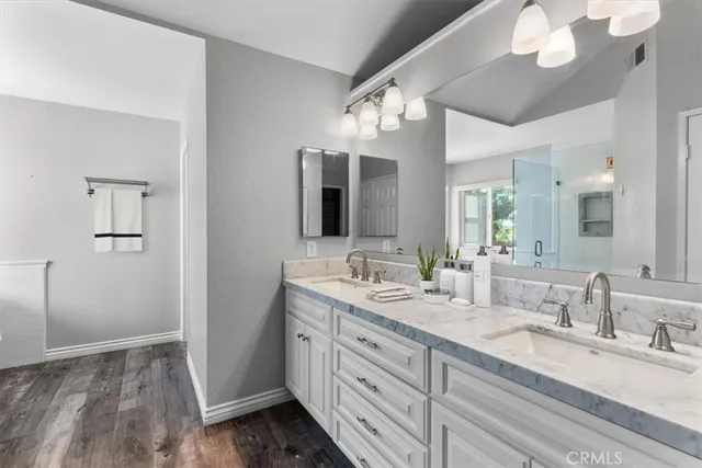 a bathroom with double vanity sink and a mirror