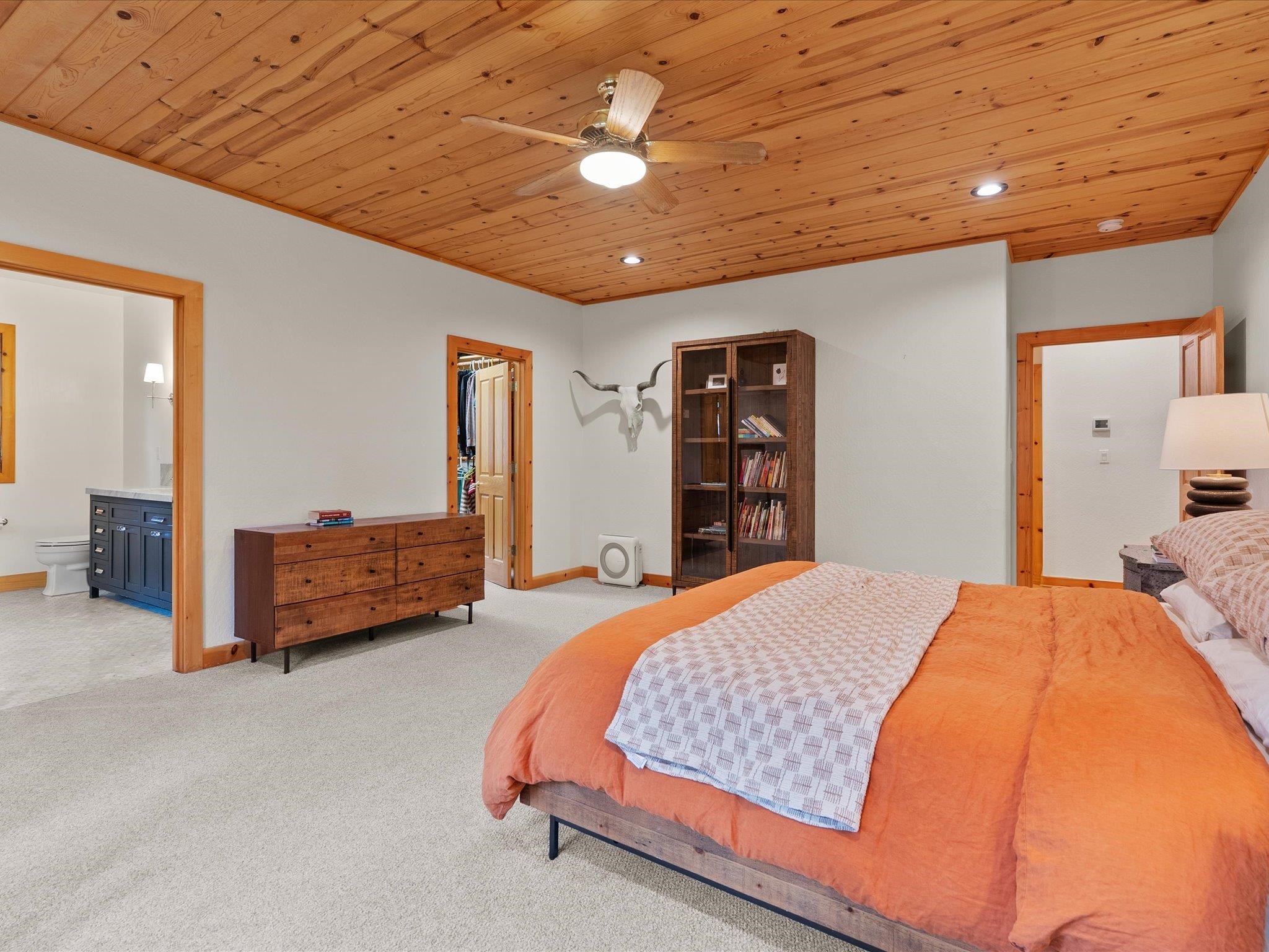 355 Quail View Circle Clio, CA 96106 - Photo 31 of 48 a bedroom with a bed and a chandelier