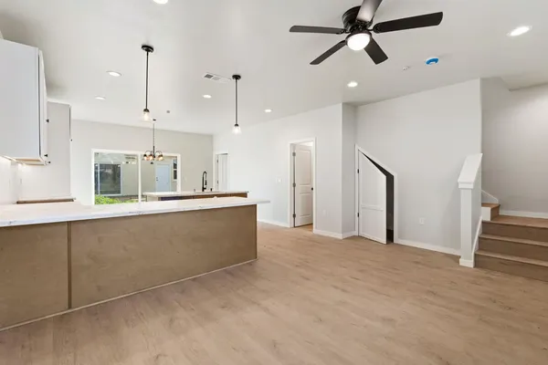 a view of kitchen with refrigerator and window