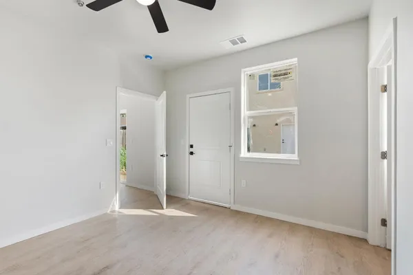 a bathroom with a granite countertop toilet and sink