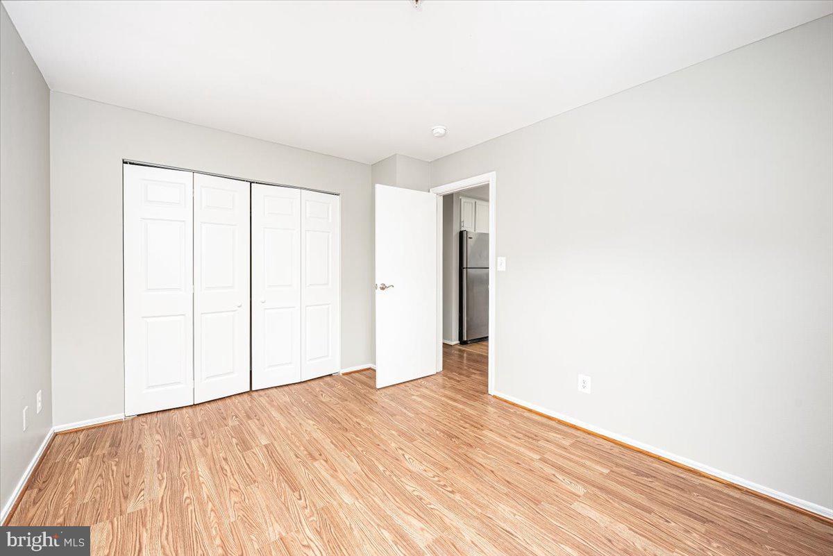 9901 Boysenberry Way, Unit 24018 Gaithersburg, MD 20879 - Photo 15 of 26 a view of empty room with wooden floor