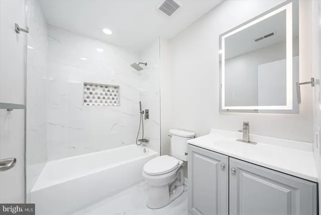 a bathroom with a toilet a sink and a bathtub