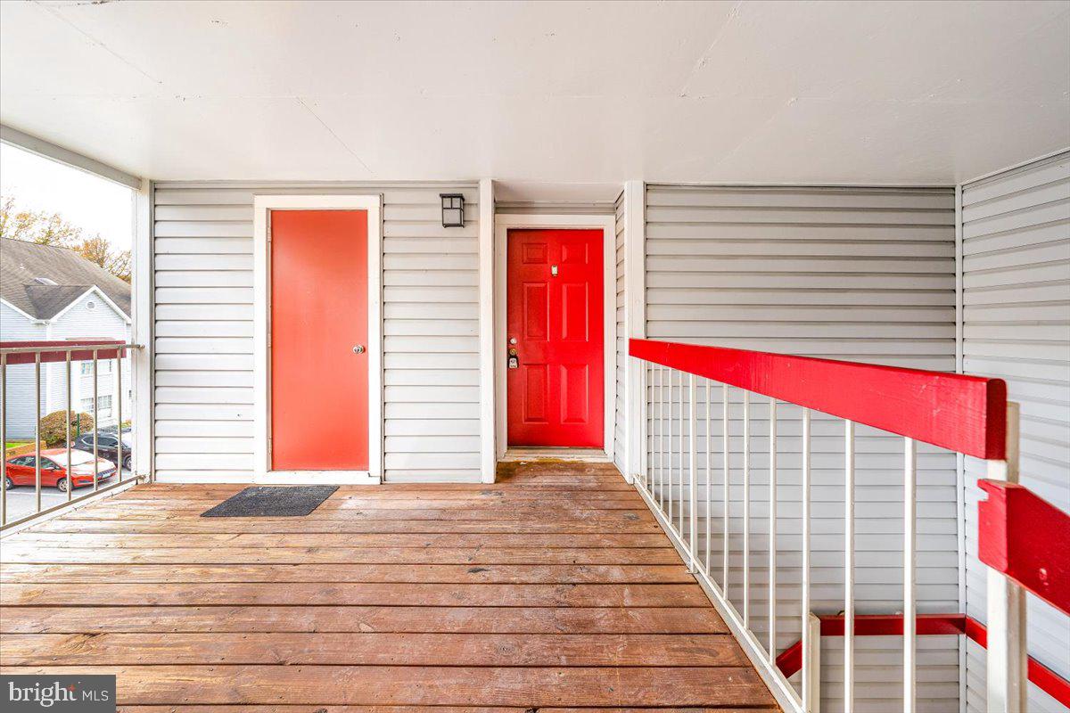 9901 Boysenberry Way, Unit 24018 Gaithersburg, MD 20879 - Photo 17 of 26 a view of a balcony with door and wooden floor