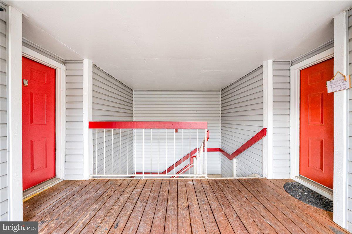 9901 Boysenberry Way, Unit 24018 Gaithersburg, MD 20879 - Photo 20 of 26 a view of a balcony with wooden floor and stairs