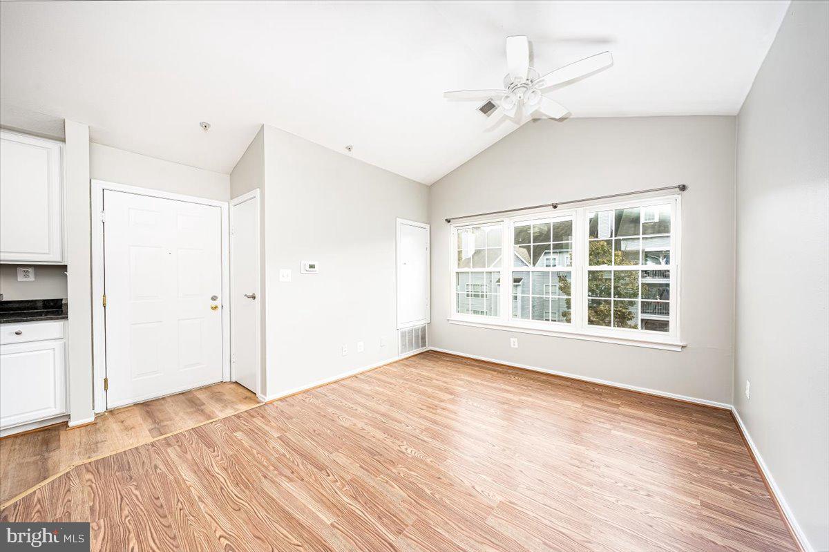 9901 Boysenberry Way, Unit 24018 Gaithersburg, MD 20879 - Photo 4 of 26 a view of empty room with wooden floor and fan